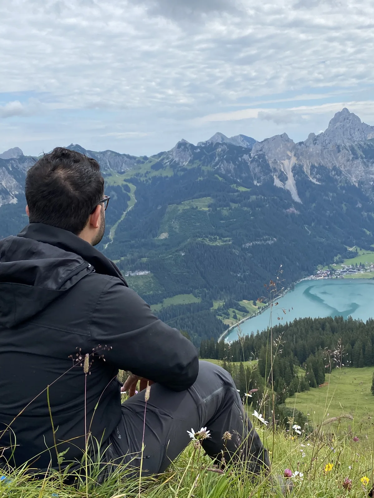 Amanj looking out over a mountain lake